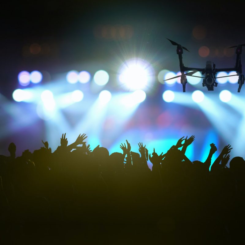closeup-silhouette-of-drone-flying-for-taking-video-of-concert-crowd.jpg